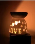 Ceramic oil burner with love candle and star cut-outs
