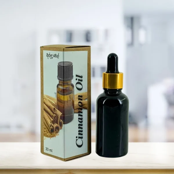 Cinnamon essential oil bottle with gold neck ring and brown paper box on light surface