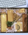 Ecofriendly corporate gift pack with bamboo bottle, mug, wooden notebook, elephant phone stand, and clay flower pot