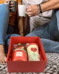 Red self-care gift box with candle, fragrance, and heart-themed mug – ideal for gifting someone special