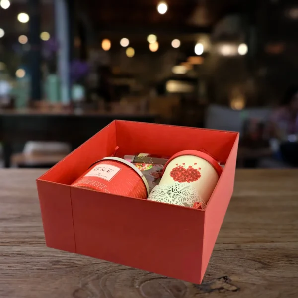 Red self-care gift box with candle, fragrance, and heart-themed mug – ideal for gifting someone special