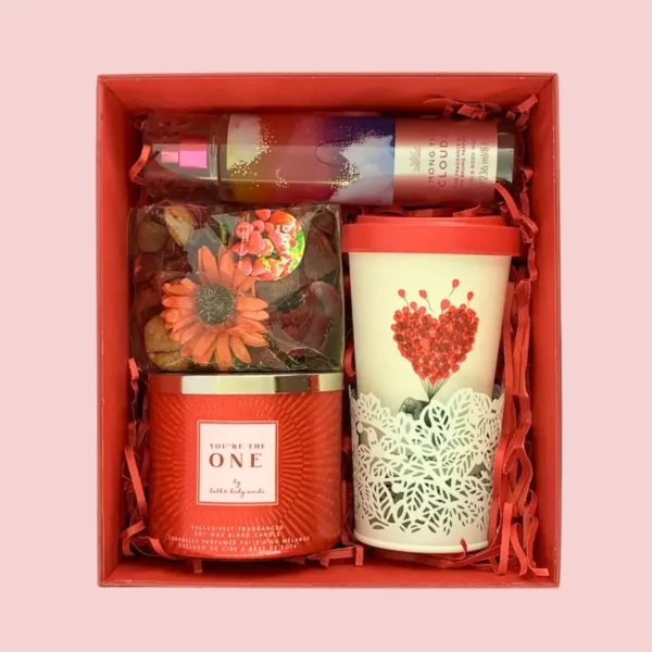 Red self-care gift box with candle, fragrance, and heart-themed mug – ideal for gifting someone special