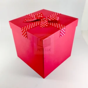 Red gift box with white polka dot ribbon for festive and romantic gifting