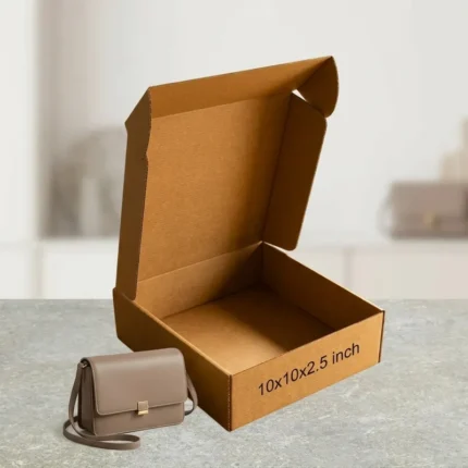 An open kraft brown 3 ply corrugated box showing dimensions 10x10x2.5 inch