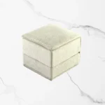 Premium White Velvet Ring Box featuring a luxury engagement ring on a wedding-themed background.
