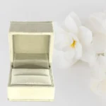 Premium White Velvet Ring Box featuring a luxury engagement ring on a wedding-themed background.