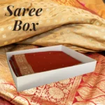 White Saree Box made of 350gsm board containing a folded red and gold bridal saree