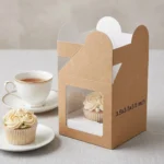 single brown kraft paper cup cake box with an inside white holder insert and clear viewing window, sized 3.5x3.5x3.5 inches.