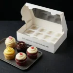 Premium white 12-cupcake box with an oversized clear window and custom internal tray showing 13x9.5x3.5 inch size dimensions